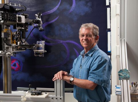 Paul Kirby, The Fusioneer and modern inventor next to Dulcinea the painting robot