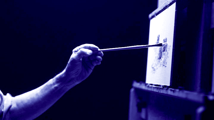 A close-up of an arm using a basic paintbrush techniques